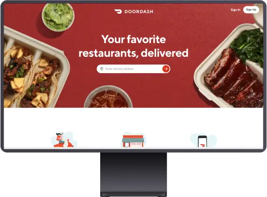 A monitor showing the Doordash homepage