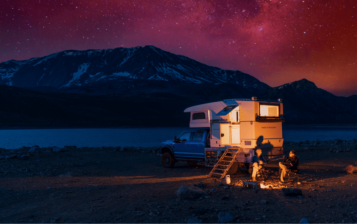 campers enjoying an evening outside a nimbl truck